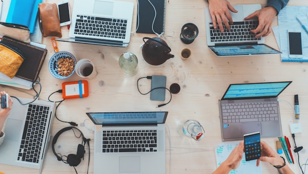 Business team using laptops and smartphones in the office